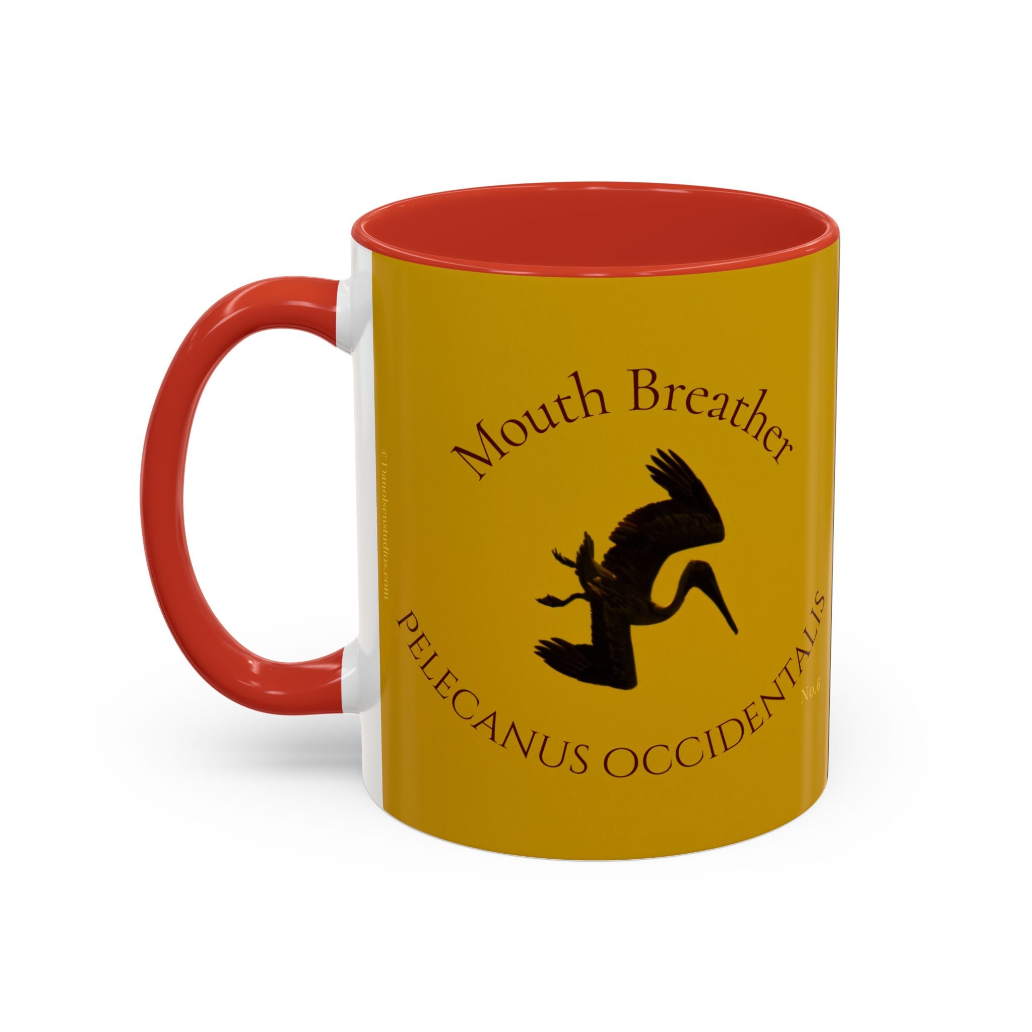 Yellow mug with red interior and handle featuring a diving pelican design and text.