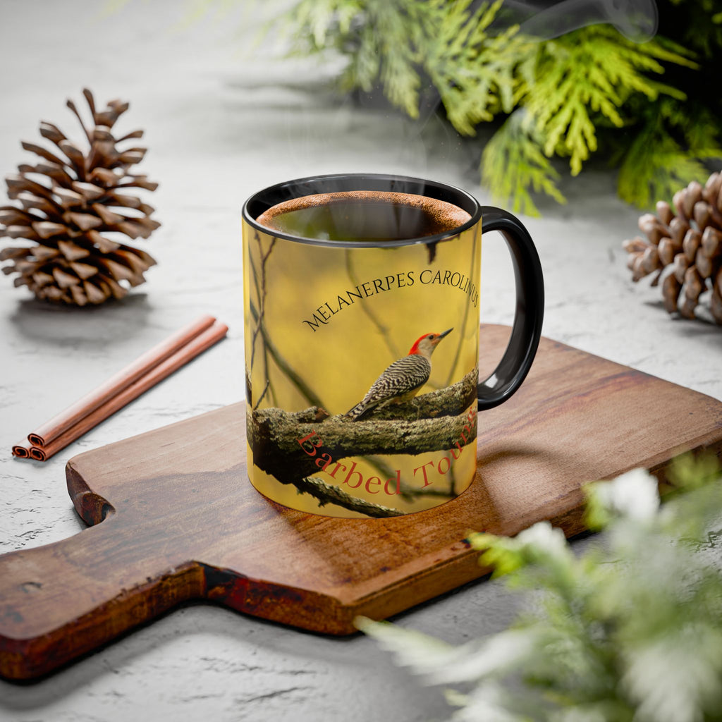 Mug with Red Bellied Woodpecker design on a wooden cutting board with pine cones and cinnamon sticks.